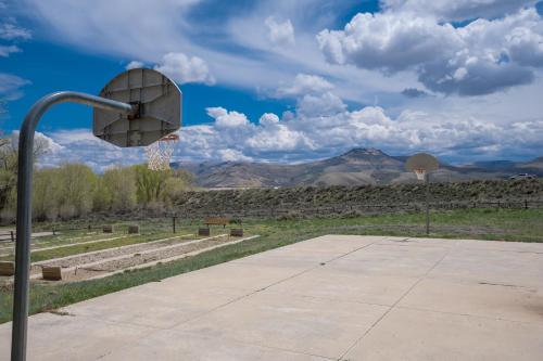 a basketball hoop in a park with mountains in the background at Thousand Trails Blue Mesa Recreational Ranch in Hierro