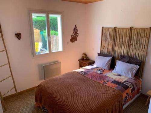 - une chambre avec un lit et une fenêtre dans l'établissement Charmant appartement, à Andernos-les-Bains