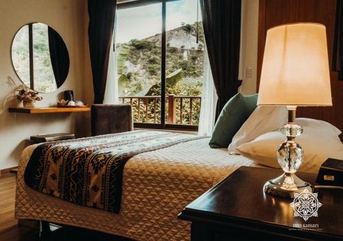 a hotel room with a bed and a window at Inti Kamari Wellness Lodge & Convention Center in Santa Isabel