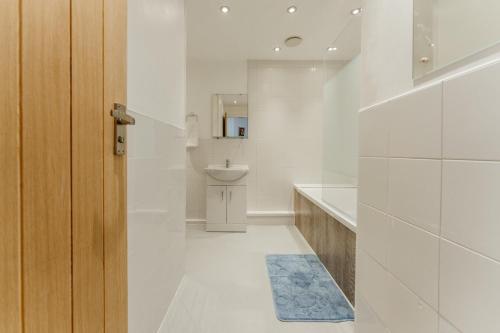 a white bathroom with a sink and a toilet at LimeHouse Double Rooms - 3 in London