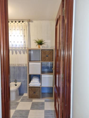 a bathroom with a toilet and a sink at Adosado playa Rodeira in Cangas de Morrazo