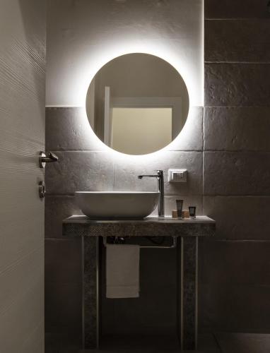 a bathroom with a sink and a mirror at Palazzo Matà Boutique Hotel in Taranto