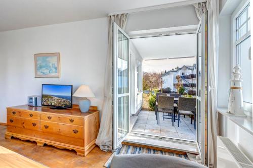 a bedroom with a large glass door leading to a patio at Strandnähe! Moderne 3 Zimmer Ferienwohnung!! in Bansin