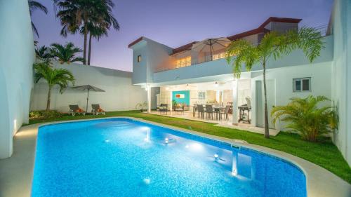 a house with a swimming pool in front of a house at Casa Melanie, Alberca y Asador Privados in Puerto Vallarta