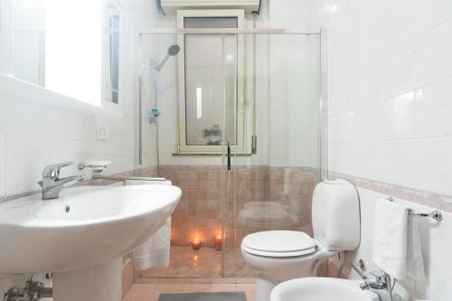 a bathroom with a toilet and a sink and a shower at Nina Home - Selfcheck-in in Canicattini Bagni