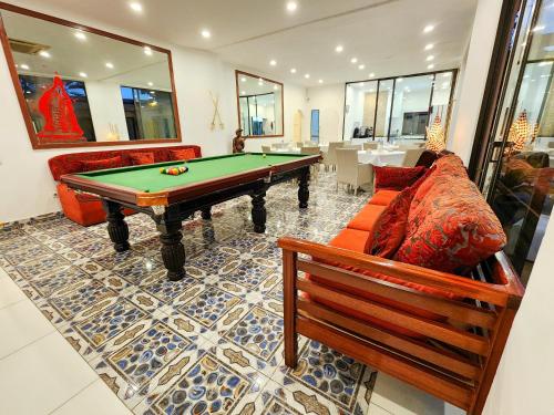 a living room with a pool table and a couch at Villa das Ar&aacute;bias Boutique Hotel in Maputo