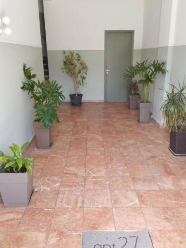 a room with potted plants on the floor at apt.27-103 in Nafplio