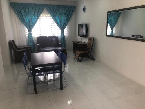 a living room with a television and a mirror at AGMA Homestay in Kuantan