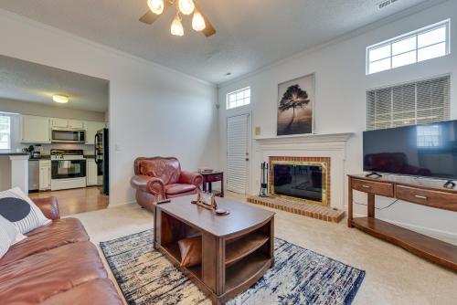 a living room with a couch and a fireplace at Charlotte Vacation Rental Near Motor Speedway! in Charlotte