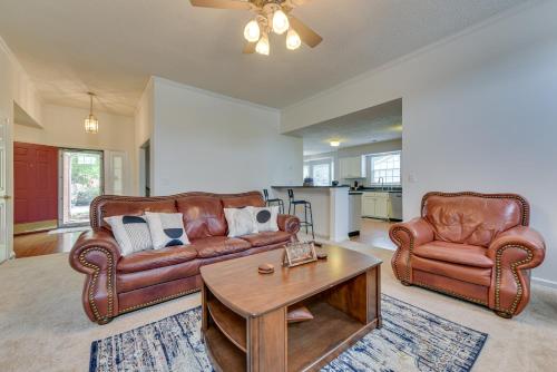 a living room with two leather couches and a coffee table at Charlotte Vacation Rental Near Motor Speedway! in Charlotte