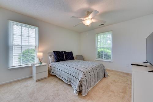 a bedroom with a bed and a ceiling fan at Charlotte Vacation Rental Near Motor Speedway! in Charlotte