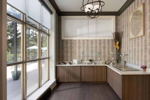 a kitchen with a sink and a large window at Sheraton Jacksonville Hotel in Jacksonville