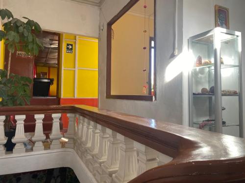 a room with a staircase with a mirror and a shelf at pusary hostel in Arequipa