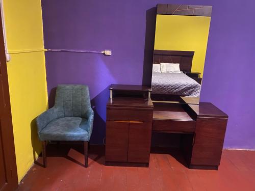 a bedroom with a mirror and a chair and a bed at pusary hostel in Arequipa