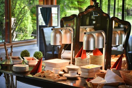 a table with plates and other food on top at Parkhotel Morris Novy Bor in Nový Bor