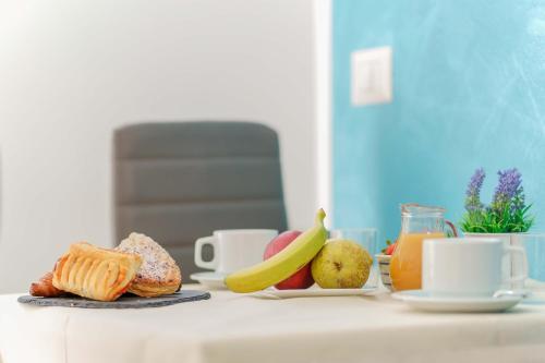 a table topped with plates of food and fruit at CalaBisso in Calasetta
