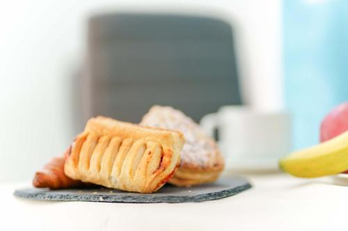 a plate with two pieces of bread on a counter at CalaBisso in Calasetta