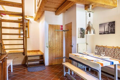 a kitchen with a staircase and a table and chairs at Forsthof Schulte in Pronstorf