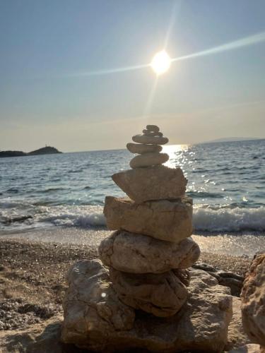 a stack of rocks sitting on the beach at Apartments Luna in Žuljana