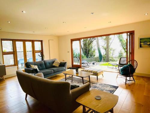 a living room with a couch and a table at Woodland View Stunning Spacious 5 Bedroom Holiday Home in Saint Lawrence