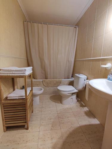 a bathroom with a toilet and a sink at Mi casita in Puerto Marino