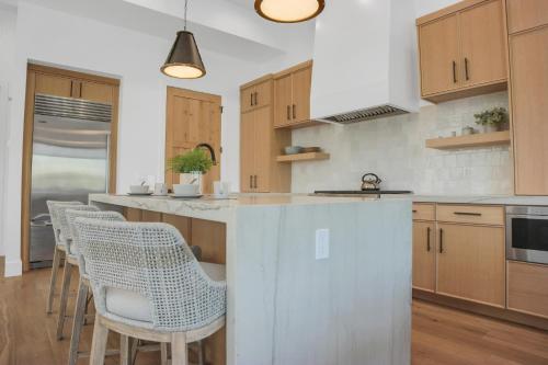 a kitchen with wooden cabinets and white counter tops at Stone Hollow 1884 townhouse in Park City