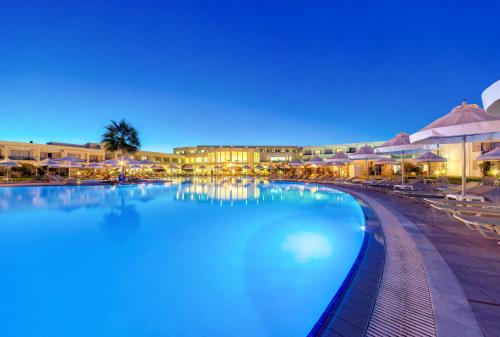 a swimming pool at a resort at night at Apollo Blue in Faliraki