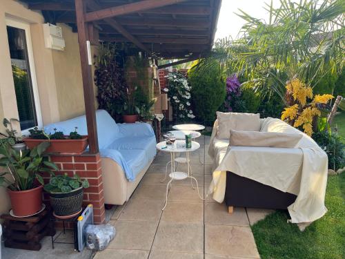 a patio with a couch and a table in a yard at Cozy room with full bathroom in Dagenham