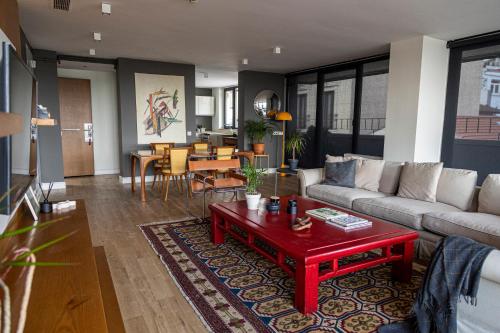 a living room with a couch and a red coffee table at GALATA M84 in Istanbul