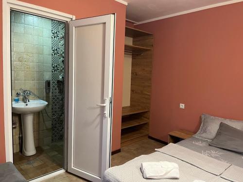 a bathroom with a bed and a sink and a shower at G32 in Tbilisi City