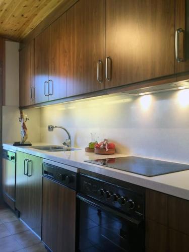 a kitchen with a sink and a stove top oven at Apartamento con vistas Taull in Taull