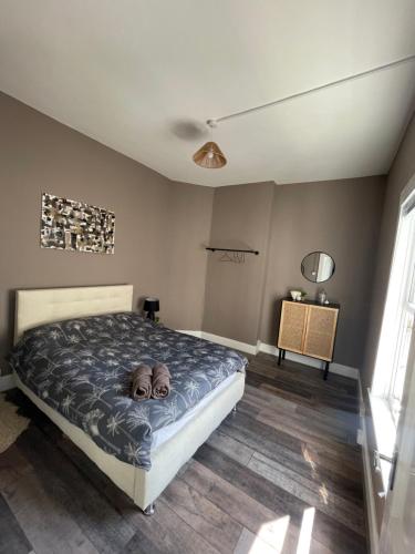 a bedroom with a dog laying on a bed at Modern 2 bed flat in Moseley in Birmingham