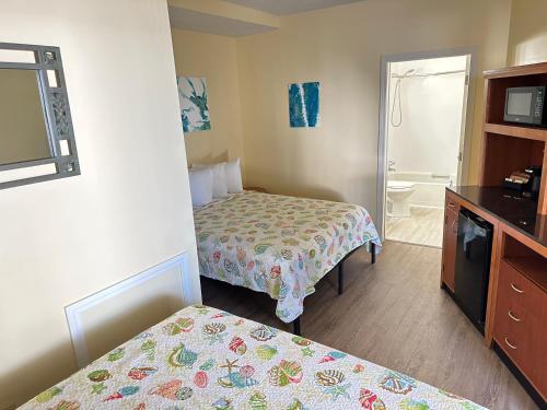 a hotel room with two beds and a bathroom at Abellona Inn & Suites in Old Orchard Beach