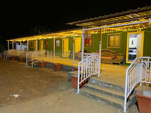 a building with lights on it at night at Green Fog Guesthouse in Lonavala