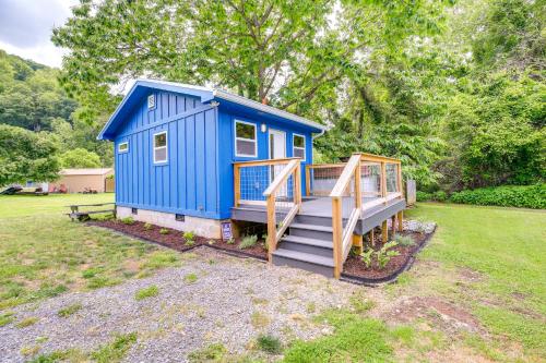 a blue tiny house with a staircase in a yard at Cozy Hikers Hideaway Steps From Creeper Trail! in Damascus