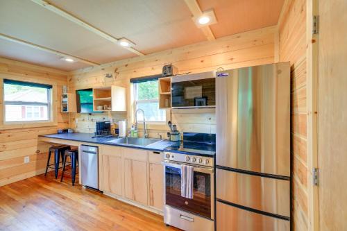 a kitchen with a stove and a refrigerator at Cozy Hikers Hideaway Steps From Creeper Trail! in Damascus