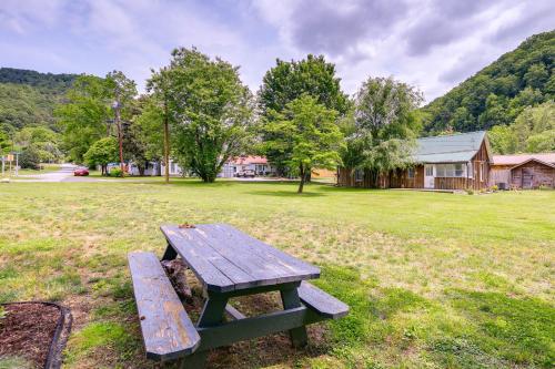 a wooden picnic table sitting in a field at Cozy Hikers Hideaway Steps From Creeper Trail! in Damascus