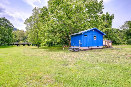 a blue shed in the middle of a field at Cozy Hikers Hideaway Steps From Creeper Trail! in Damascus