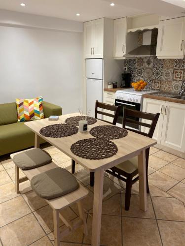 a kitchen with a table and chairs and a kitchen with a couch at Pension Hirolakas in Galaxidhion