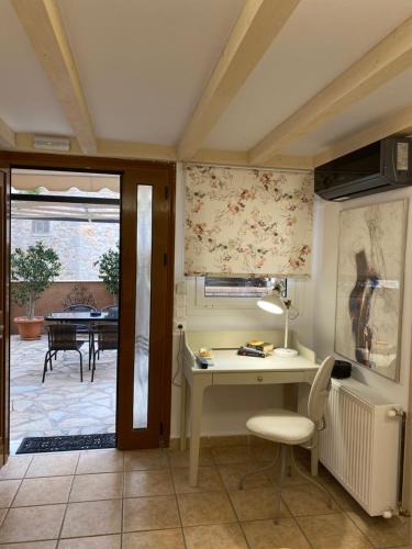 a home office with a desk and a table at Pension Hirolakas in Galaxidhion