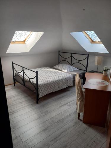 1 dormitorio con 1 cama y 2 tragaluces en Villa Osowianka, en Gdansk
