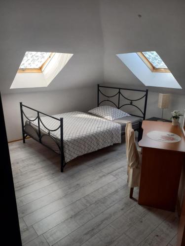 a bedroom with a bed and two skylights at Villa Osowianka in Gdańsk