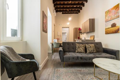 a living room with a couch and a table at Casa Palacio Rufina & Jardines in Jerez de la Frontera