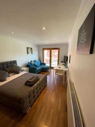 a bedroom with a bed and a living room at Lovely studio apartment in Norwich city centre in Norwich