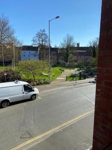 a white van is driving down a street at Lovely studio apartment in Norwich city centre in Norwich