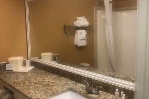 a bathroom with a sink and a mirror at Quality Inn & Suites Loveland in Loveland