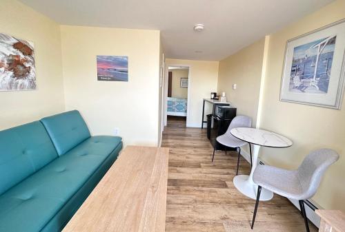 a living room with a couch and a table at Abellona Inn & Suites in Old Orchard Beach