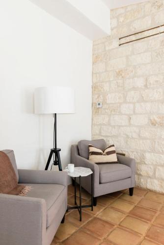 a living room with a couch and a chair at Contigo Ranch Fredericksburg in Fredericksburg