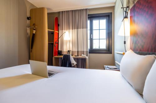 a hotel room with a bed with a laptop on it at ibis Hotel Brussels off Grand'Place in Brussels