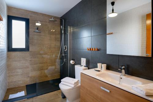 a bathroom with a sink and a toilet and a shower at Casa Sur in Conil